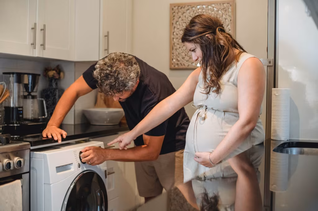 a couple trying to turn on the washing machine