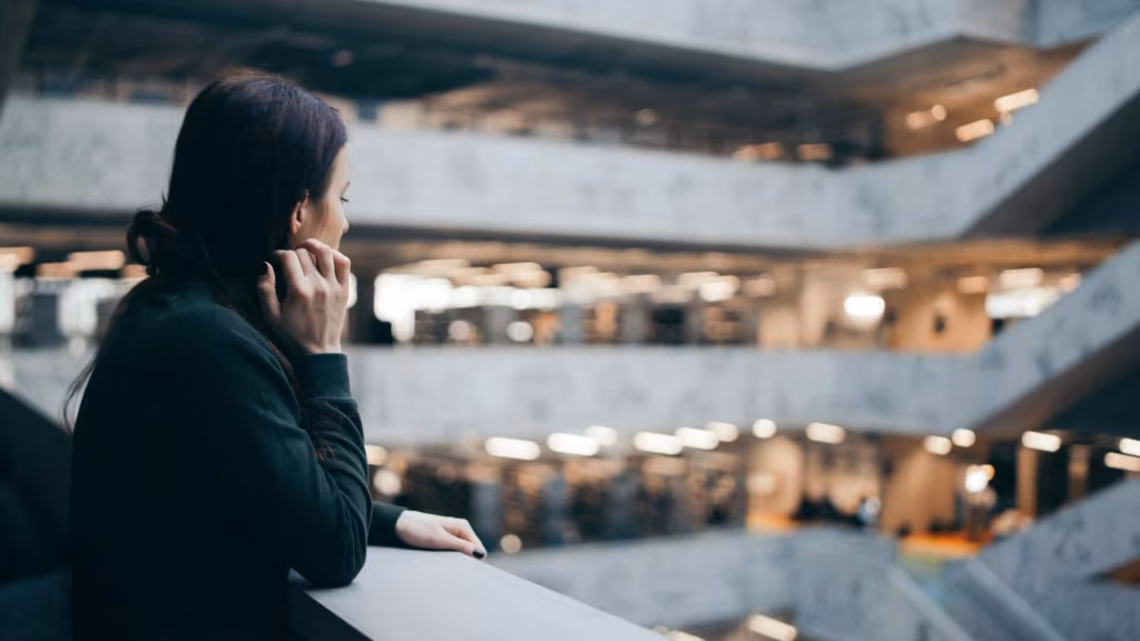a woman standing alone near a staircase