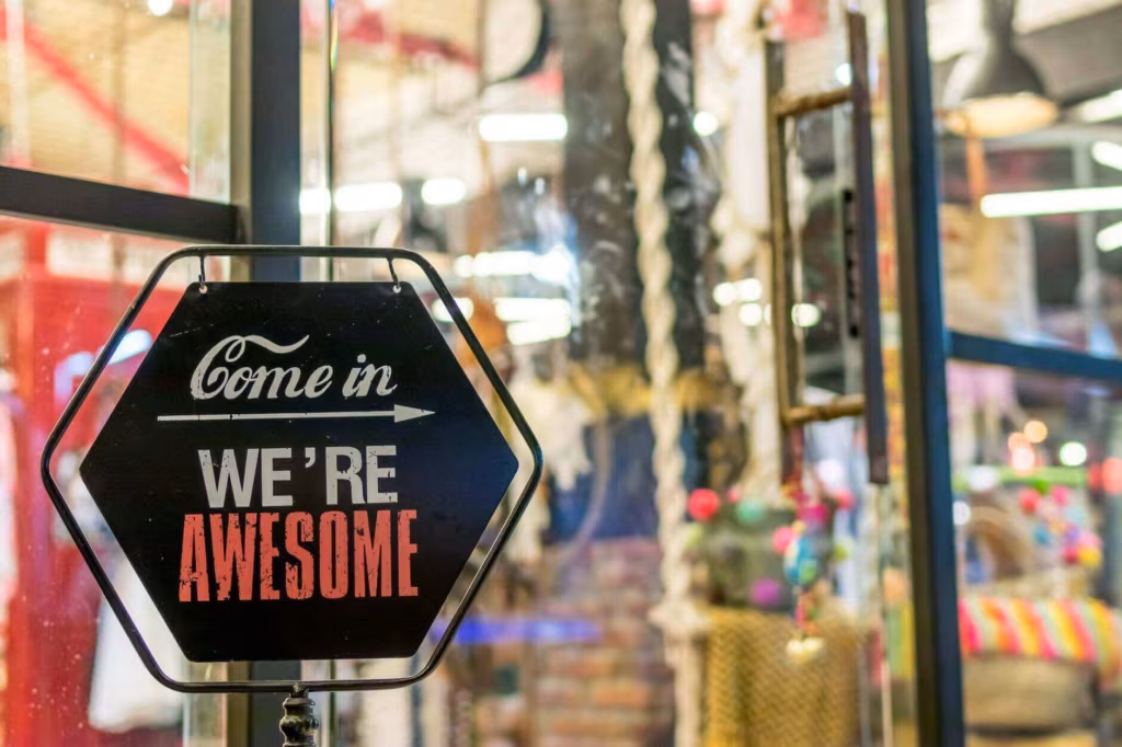 A shop window sign reading Come in, we're awesome