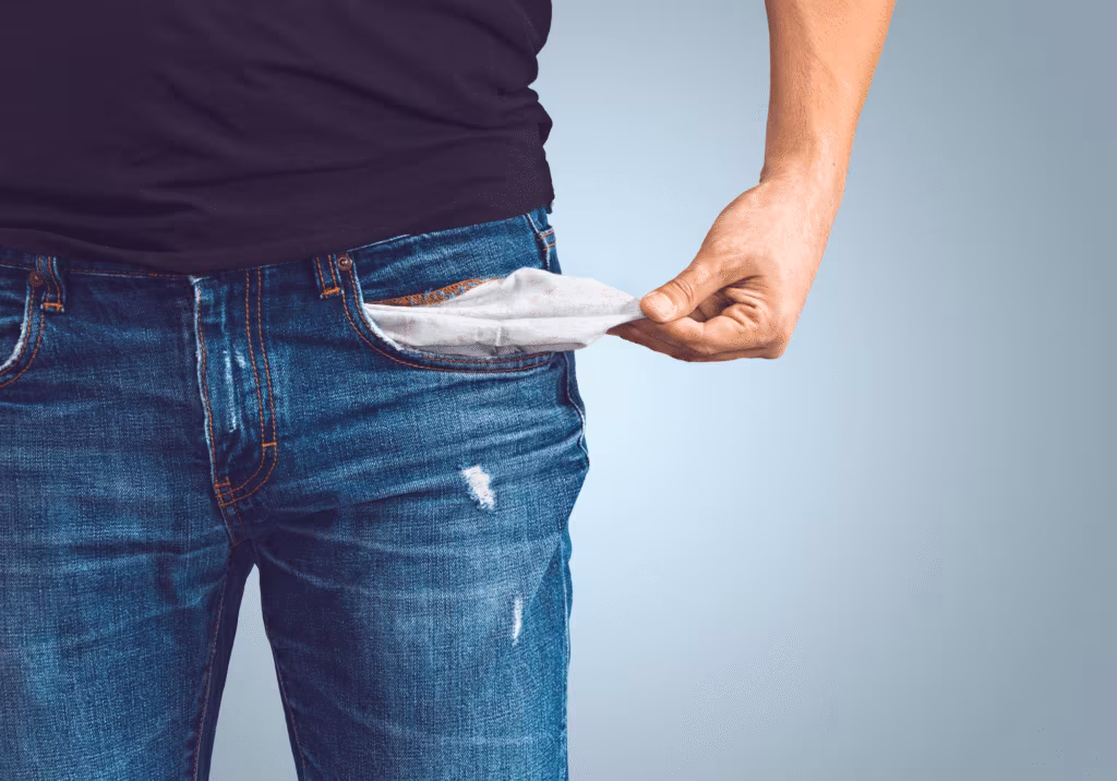 A man pulling out an empty jeans pocket