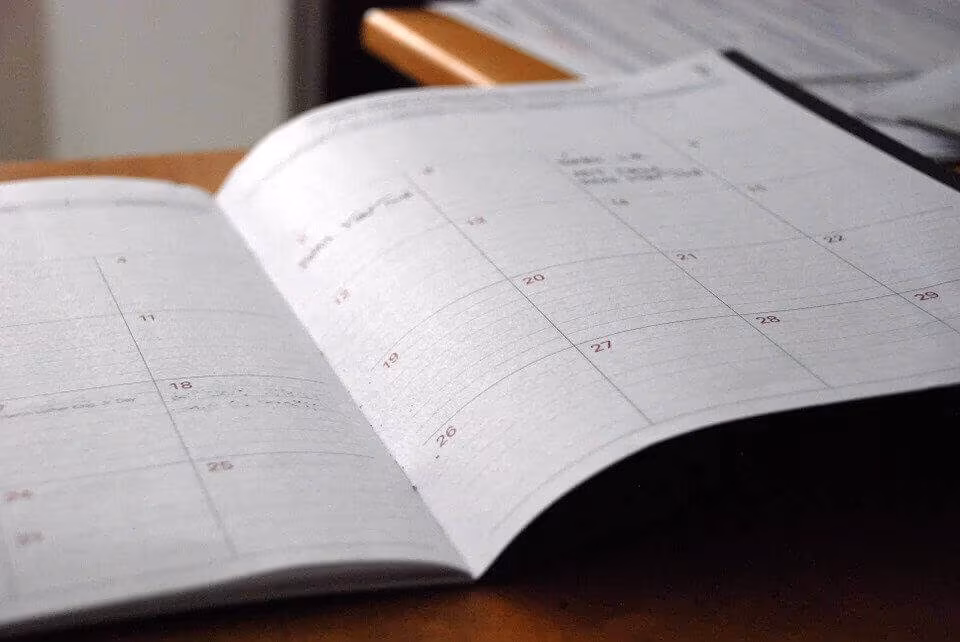 An open monthly planner lying on a desk