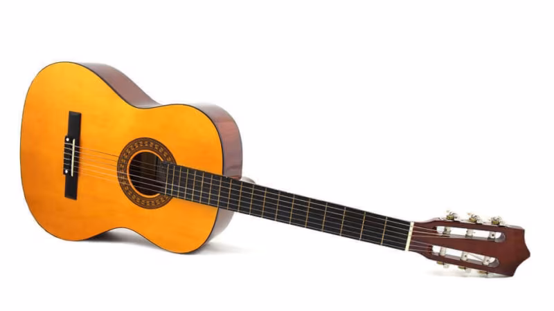An acoustic guitar against a white background