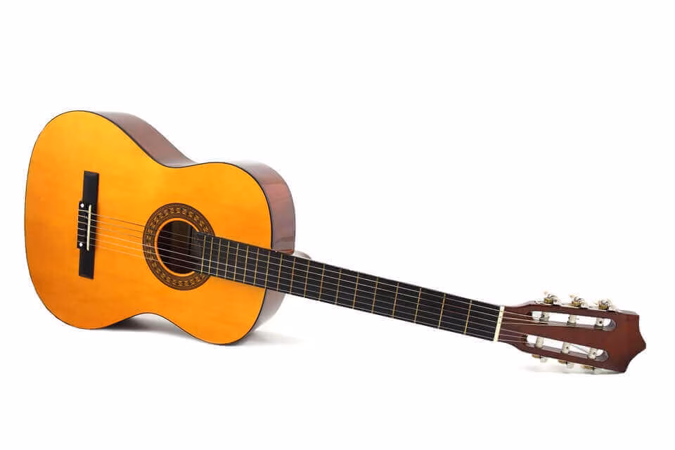 An acoustic guitar against a white background