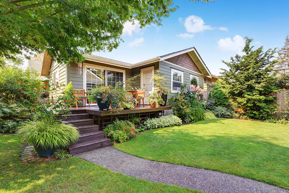 A single-storey house with a landscaped garden and a gravel path to the porch