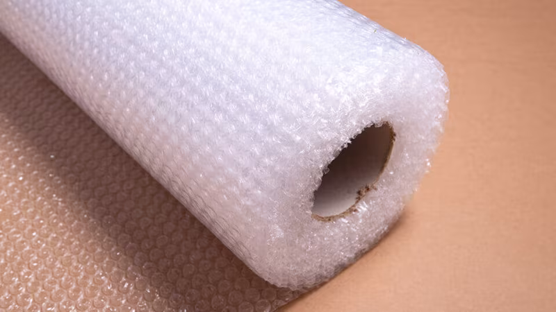 A roll of bubble wrap on a brown surface