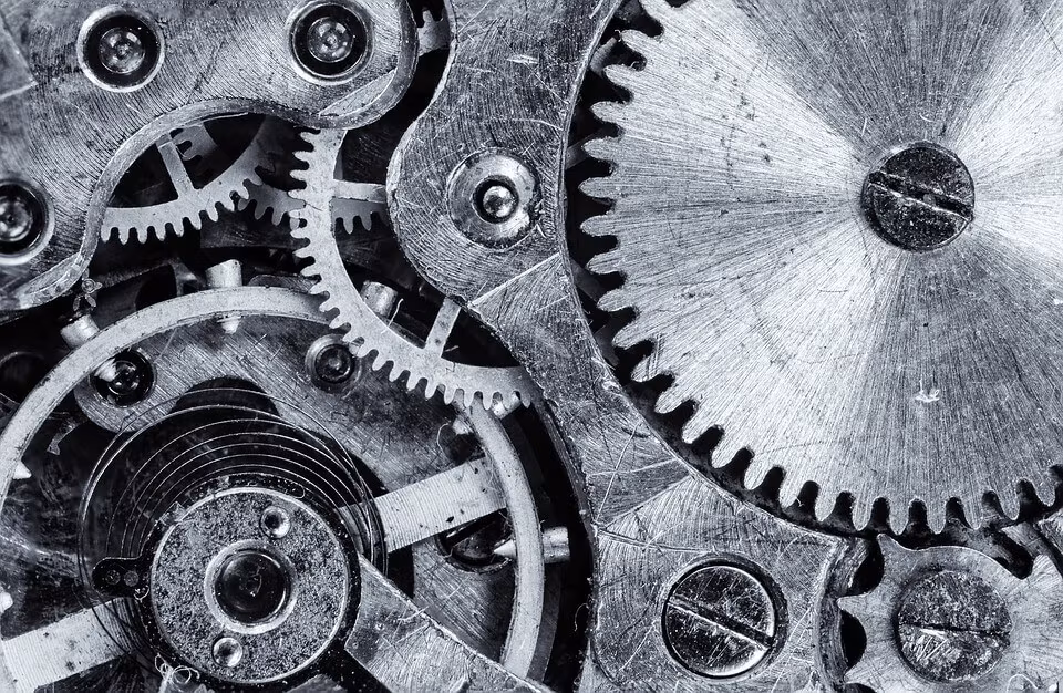 A black and white close-up of interlocking clock gears