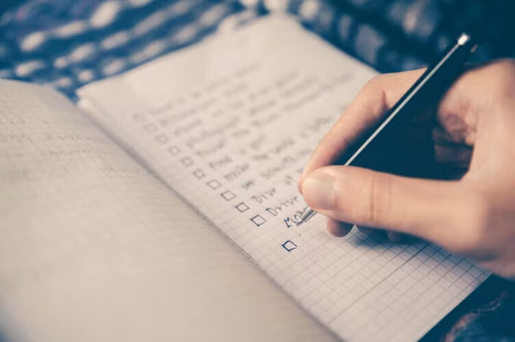 Person making a checklist for cross country moving