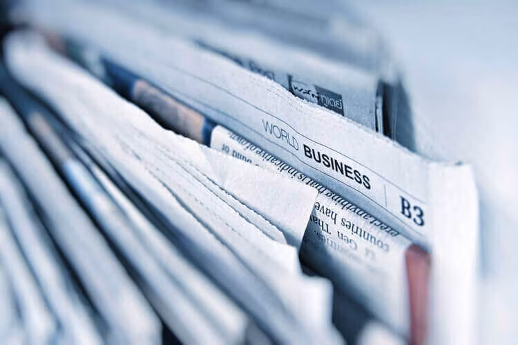 A stack of folded newspapers