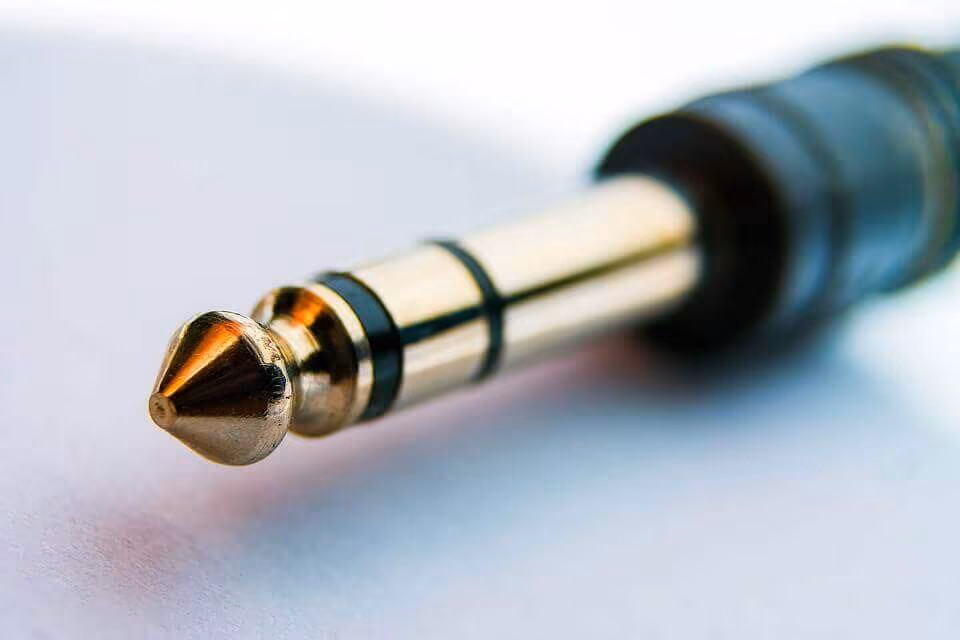 Close-up of a gold quarter-inch instrument jack plug