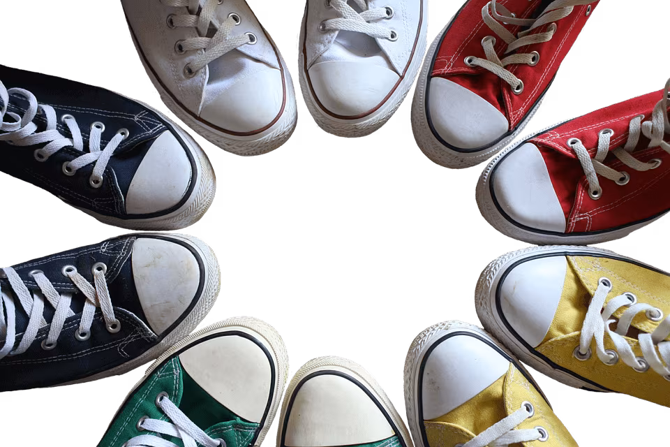 Canvas trainers in several colors arranged in a circle on a black background