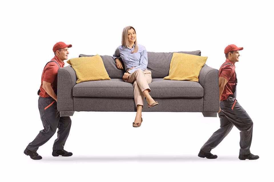 Two movers carrying a sofa with a woman sitting on it