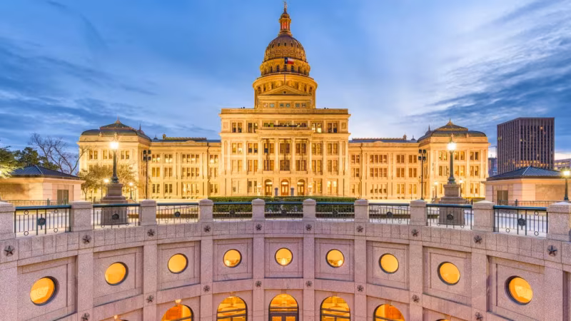 The Texas State Capitol building illuminated at dusk