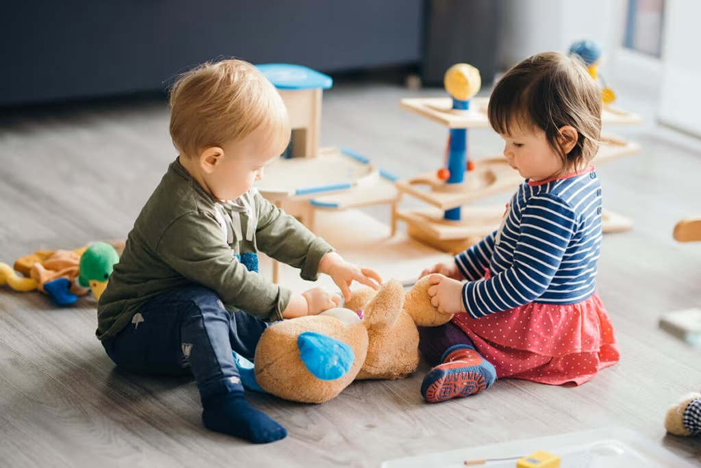 Children playing on the floor before cross country movers come