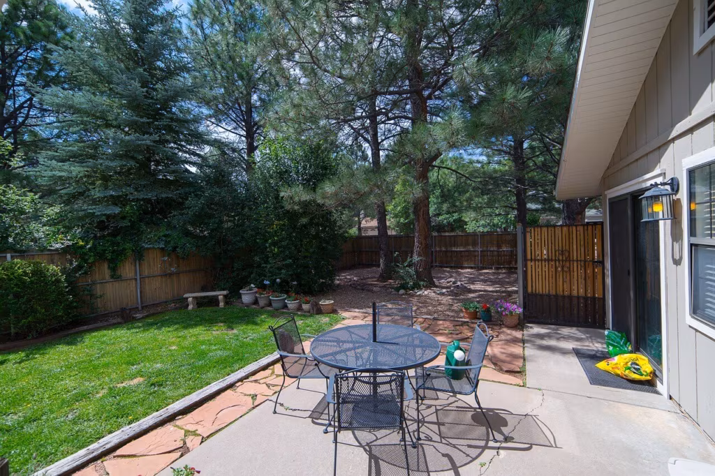 A yard with garden table and chairs