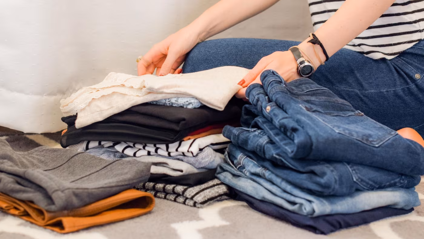 woman is sorting out her clothes