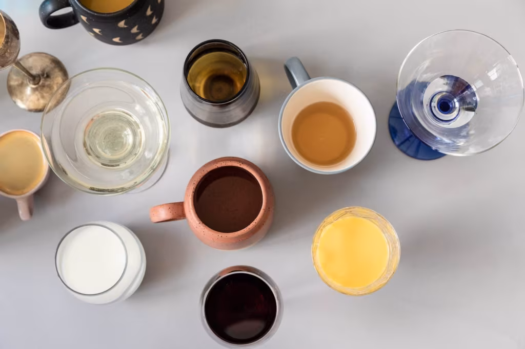 Cups and glasses on a white surface getting prepared for cross country moving company