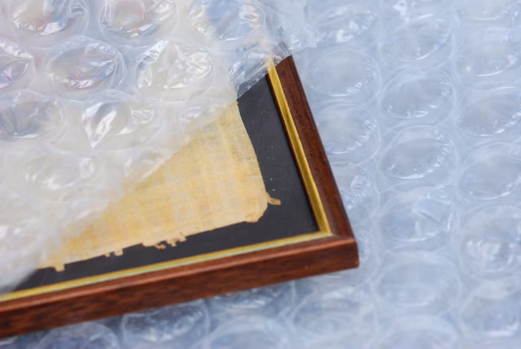 a picture peeking out from some bubble wrap, being prepared for moving cross country