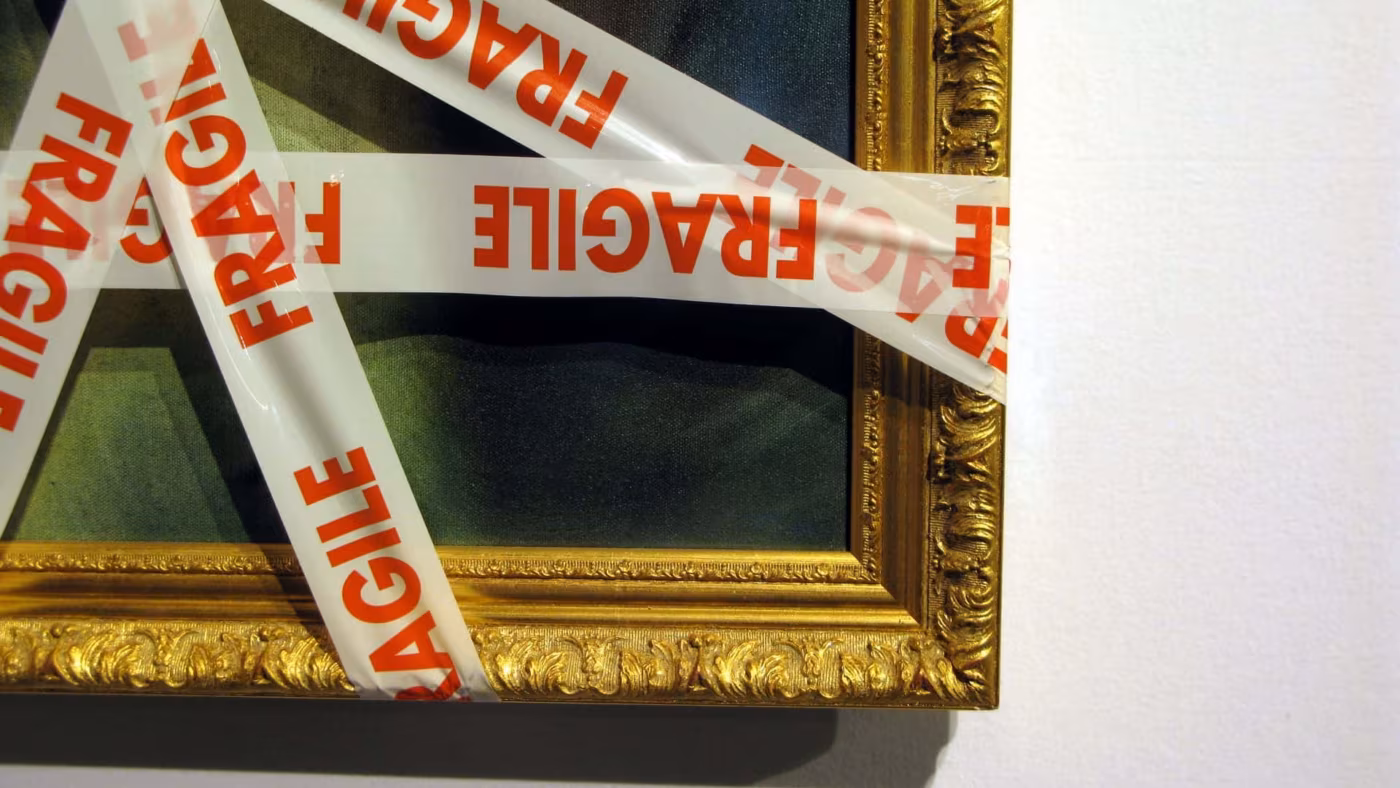 a picture wrapped in tape that says 'fragile' on it, just before cross-country moving