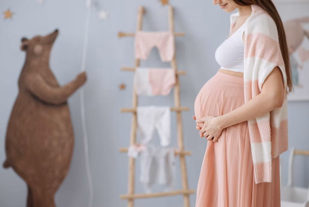 Pregnant woman in the nursery after moving across the country