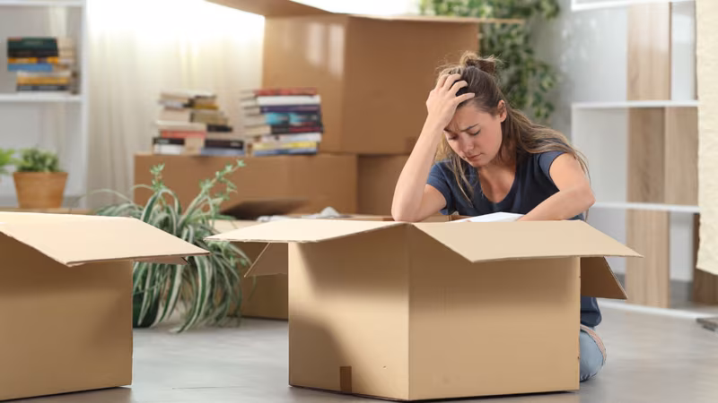 Sad girl, regretting not hiring a long-distance moving company