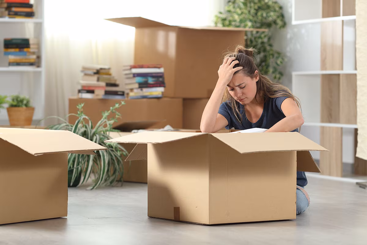 Sad girl, regretting not hiring a long-distance moving company