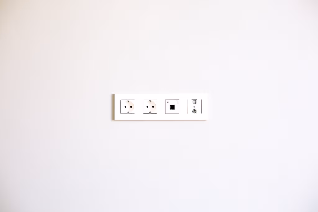 A wall socket on the white surface