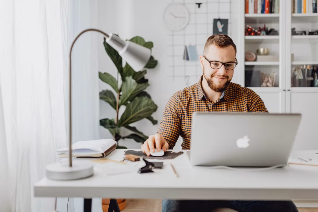 Man browsing the internet for information about cross-country moving