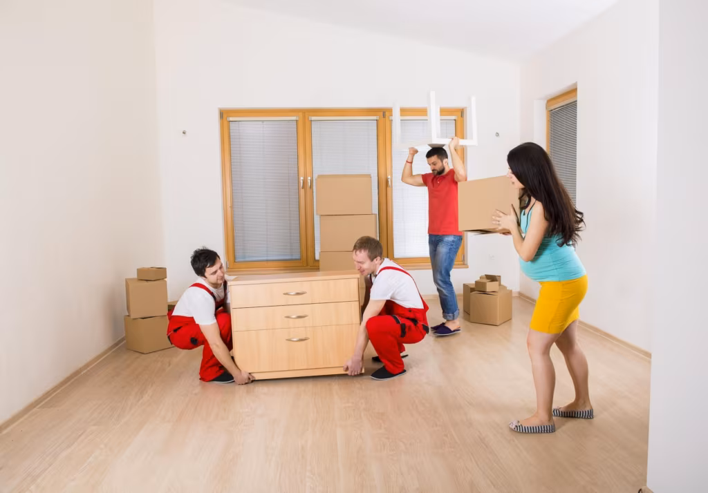 Movers from a cross country moving company carrying furniture