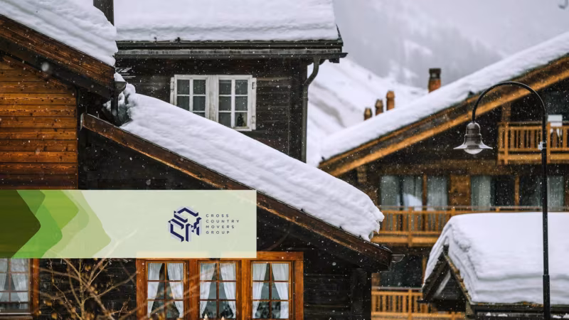 Snow-covered chalet roofs during a snowfall