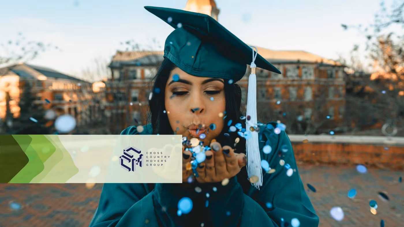 A graduate in cap and gown blowing confetti from her hand