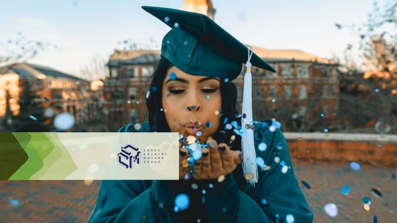 A graduate in cap and gown blowing confetti from her hand