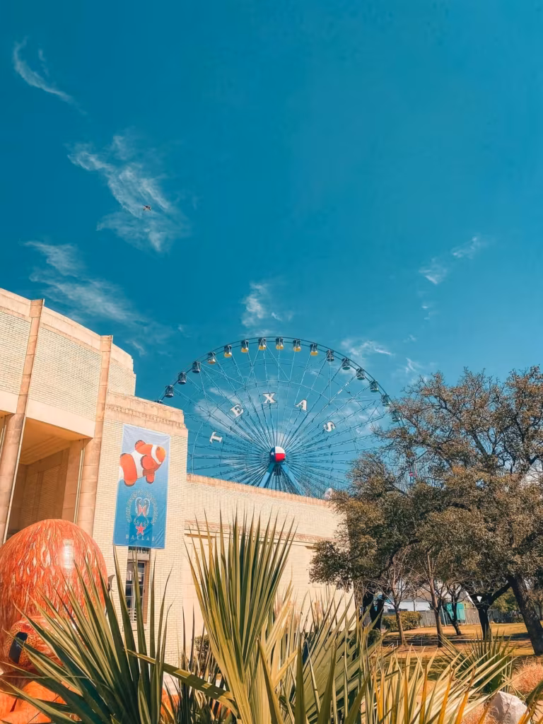 Huge Ferris wheel behind a building