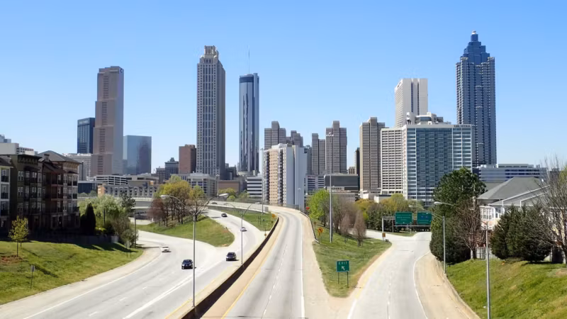A divided highway running toward the downtown Atlanta skyline