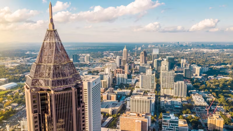 Aerial view of Atlanta with an ornate-crowned tower in the foreground