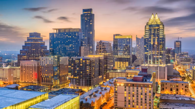 Downtown Austin at dusk, towers lit above the streets
