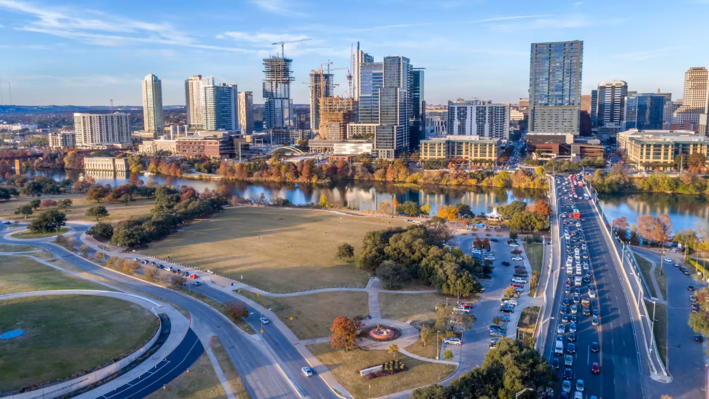 An aerial view of a highway interchange carrying traffic beside downtown Austin