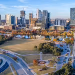 An aerial view of a highway interchange carrying traffic beside downtown Austin