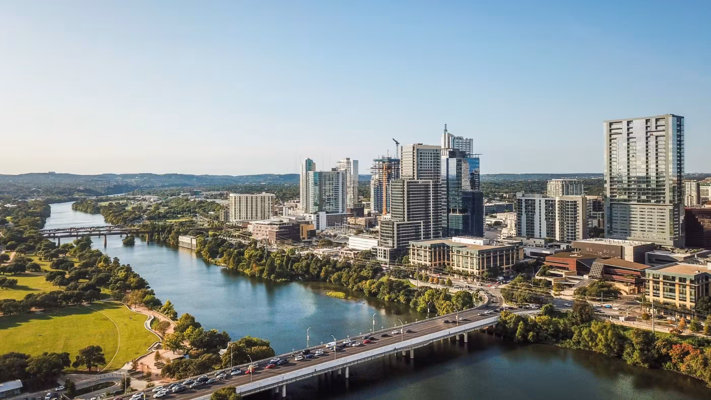 The Colorado River running past downtown Austin with traffic crossing the bridge