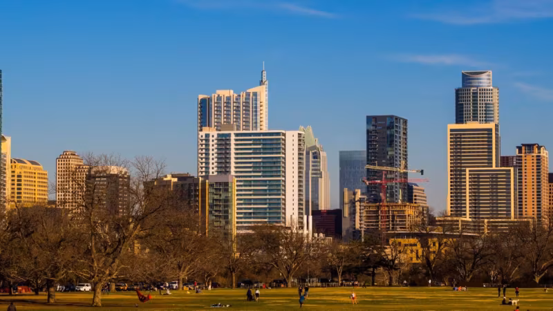 The Austin skyline seen across an open park in winter