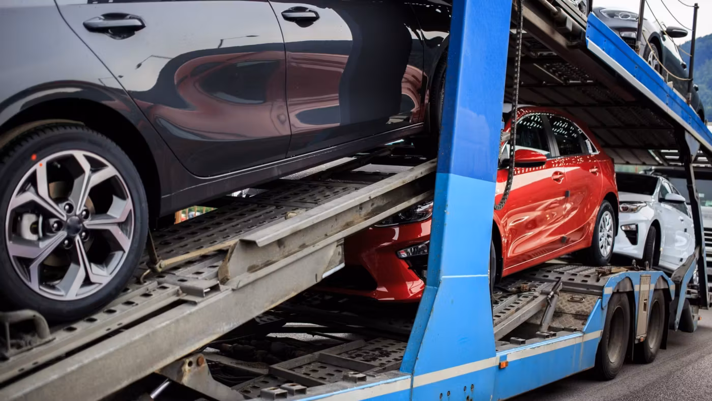 Cars strapped nose to tail on the lower deck of a car carrier