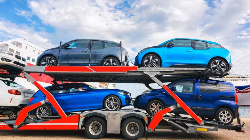 Electric cars loaded on an open car carrier