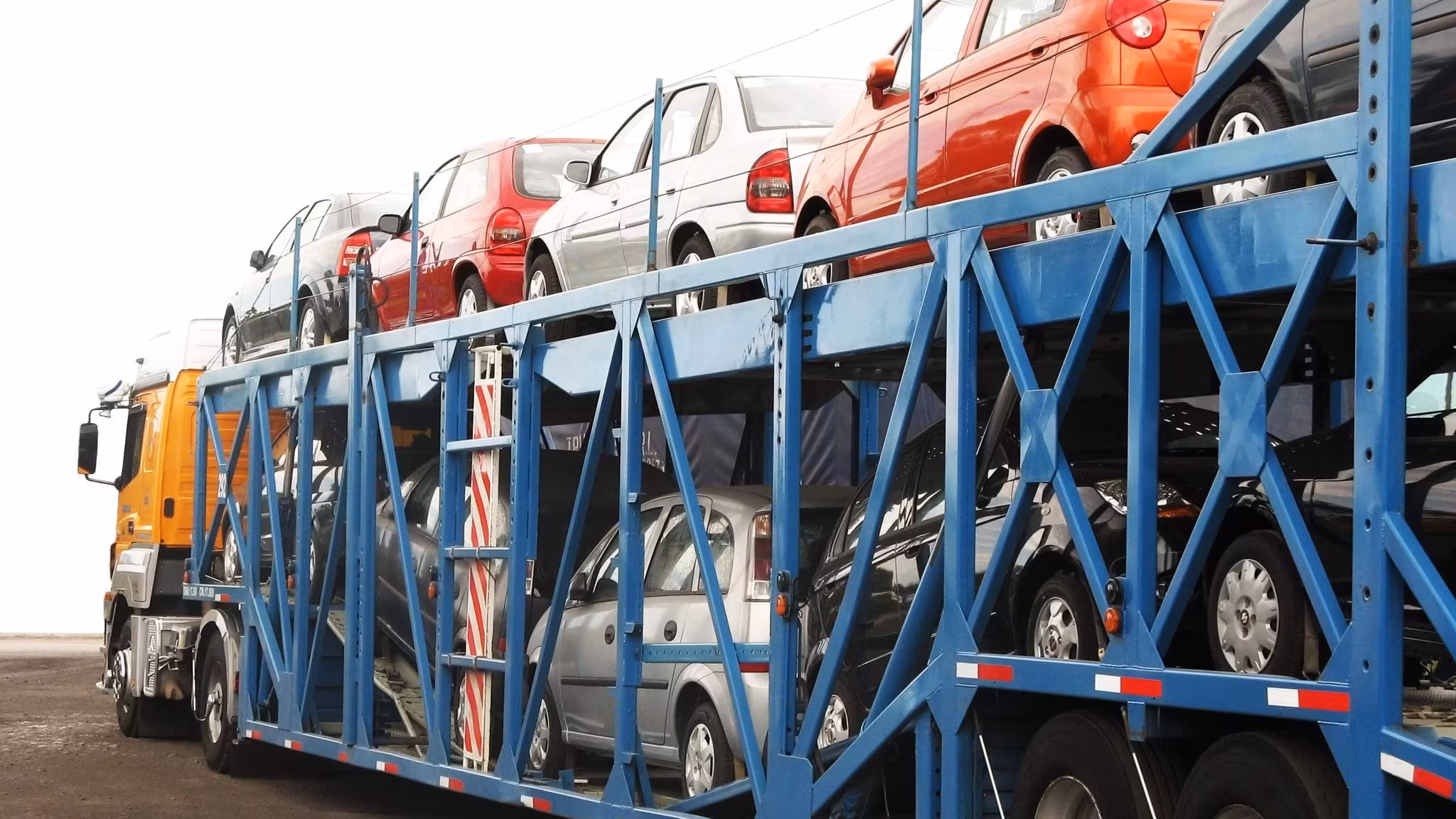An open car carrier fully loaded with vehicles on both decks