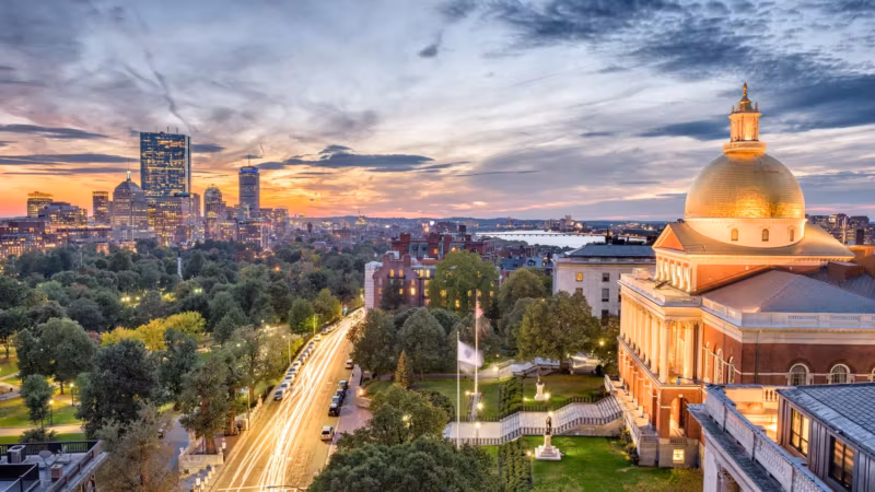 Aerial view of Boston Common and the gold dome of the State House at dusk
