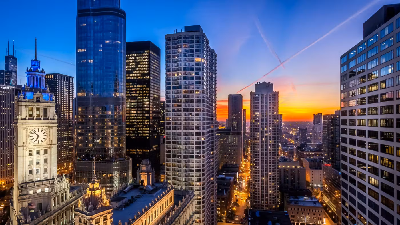 Downtown Chicago from above at sunset, the streets already lit