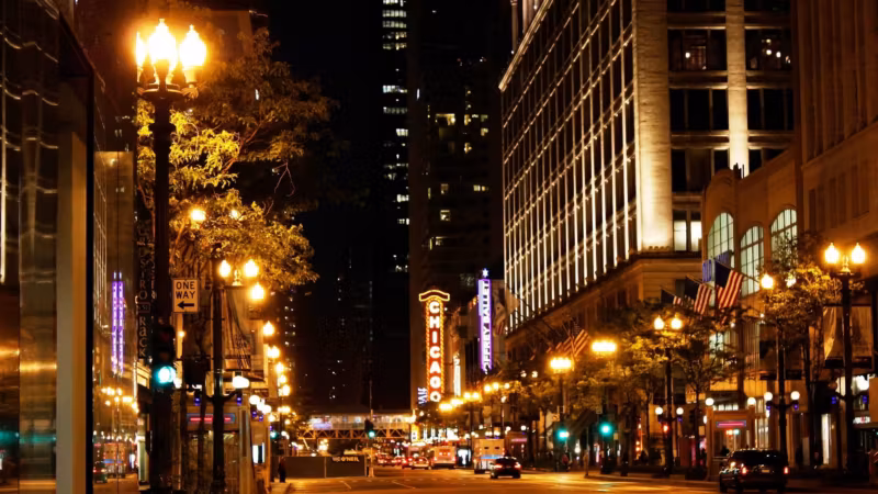 State Street in Chicago at night under lit street lamps
