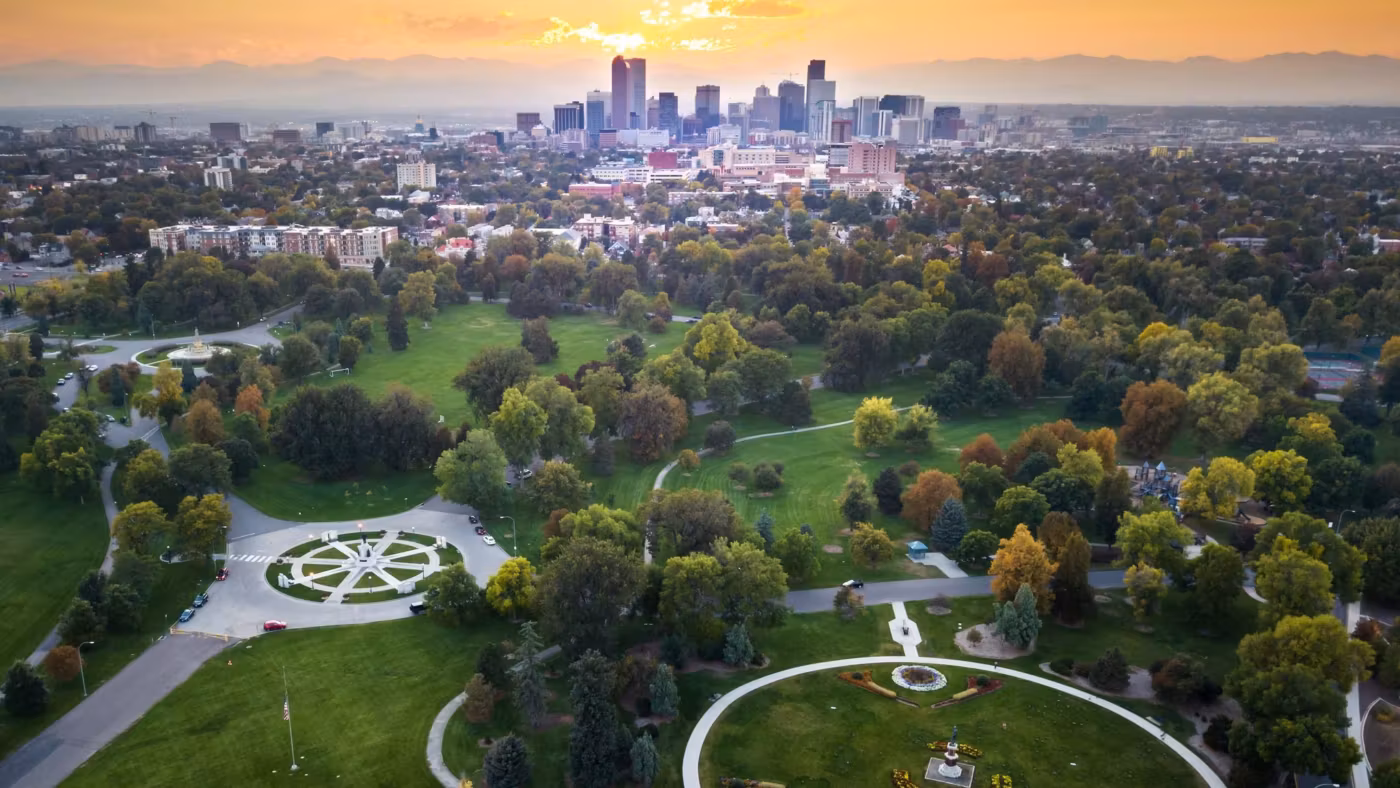 Denver's City Park from above with the downtown skyline on the horizon