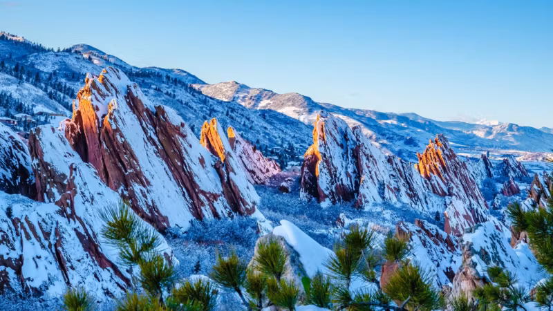 Snow on the red rock formations south-west of Denver with the Rockies behind