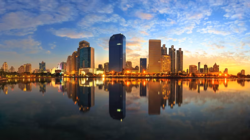 Downtown Houston reflected in still water at sunset
