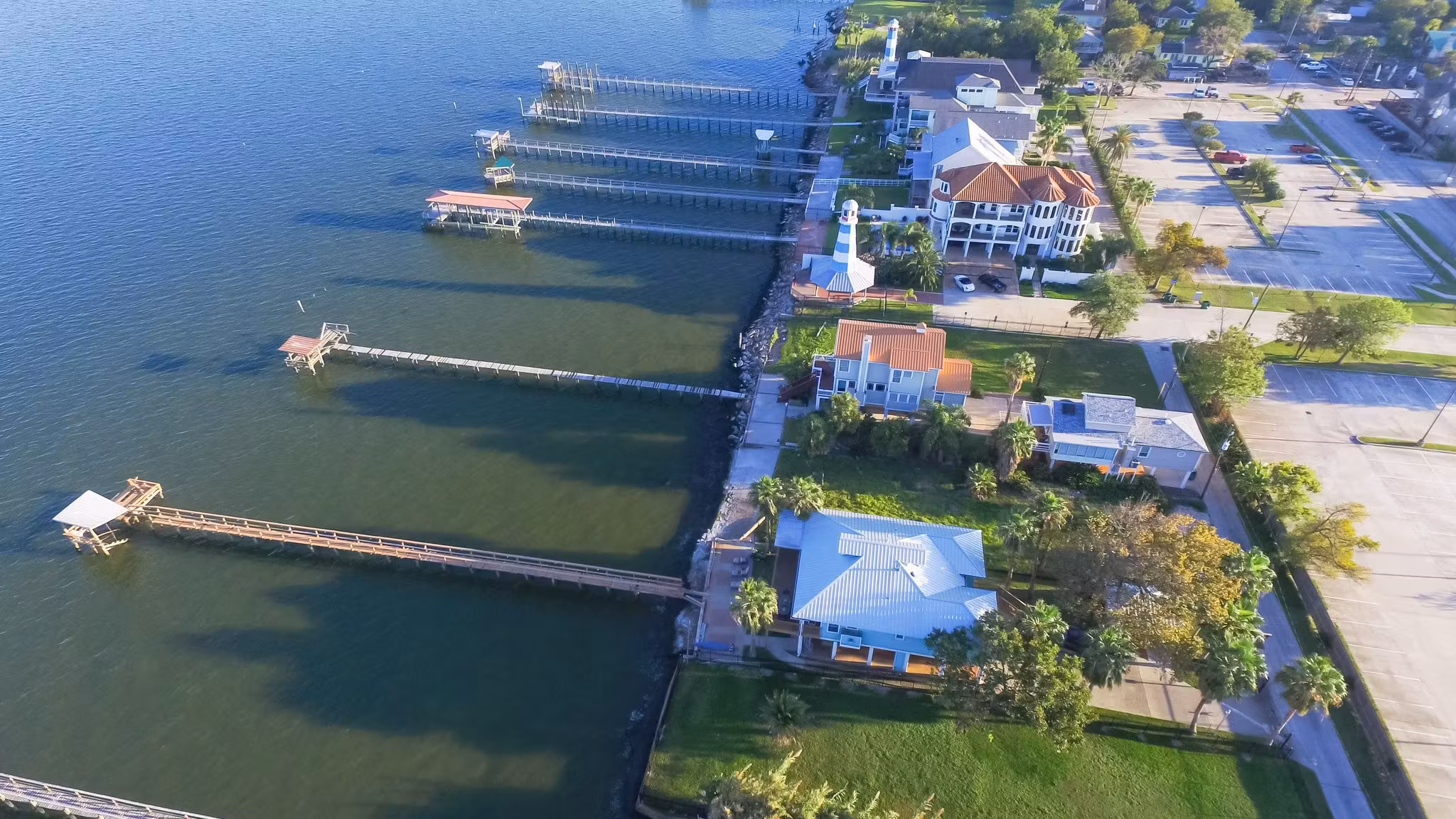 Aerial view of Houston-area homes with private piers along a lake