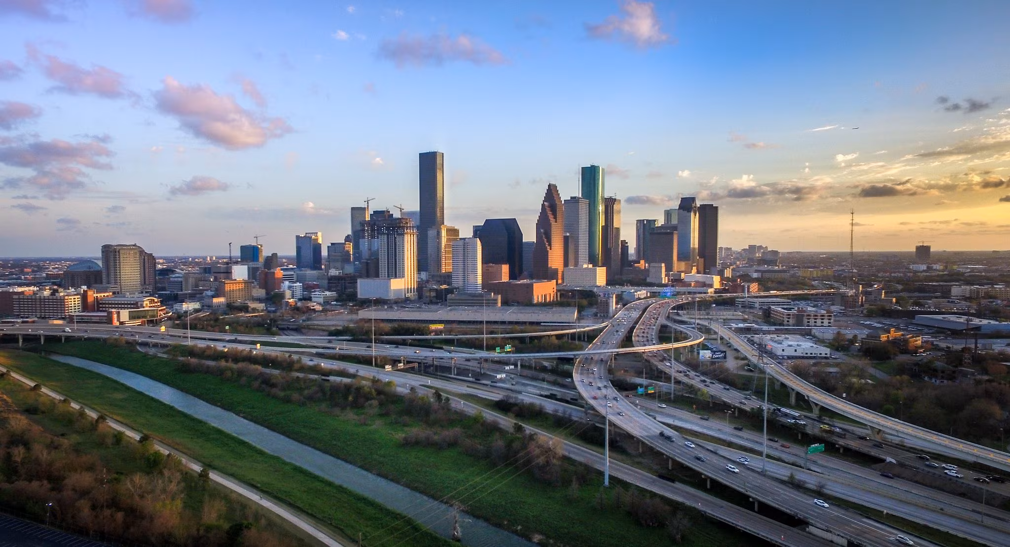 The Houston skyline above a wide freeway interchange